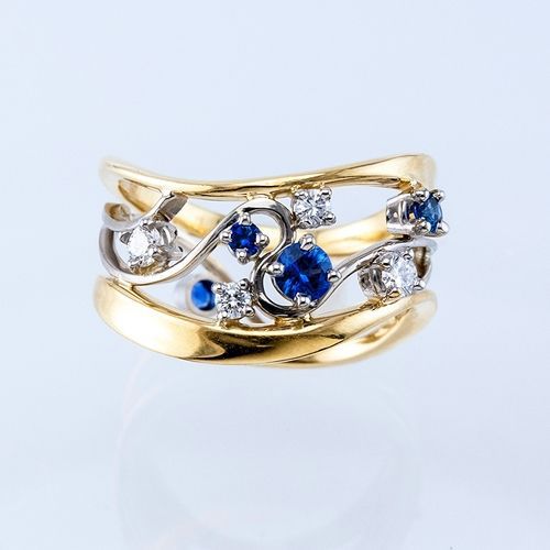 Blue and Clear Stone Gold Tone Wide Ring shown in front view