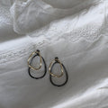 Two Tone Oval Hoop Earrings with Sculpted Polished Metal Details view 6