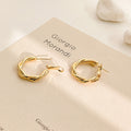 Geometric Metal Hoop Earring Collection with Sculpted Polished Metal Details view 3