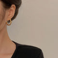 Geometric Metal Hoop Earring Collection with Sculpted Polished Metal Details view 2