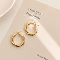 Geometric Metal Hoop Earring Collection with Sculpted Polished Metal Details view 1
