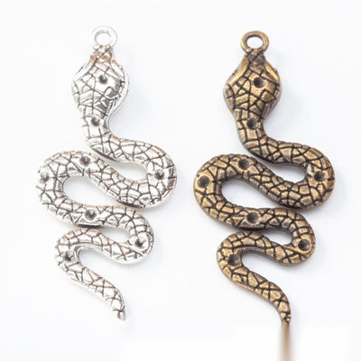 Front display of coiled snake charm shown against a plain background.