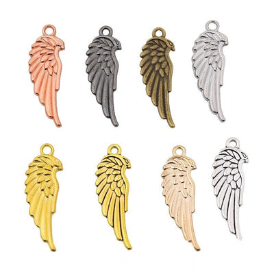 Overview of long wing charm pieces on a white background