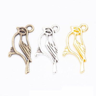 Product photo 1 of the bird on branch charm highlighting its open bird silhouette perched on a short branch