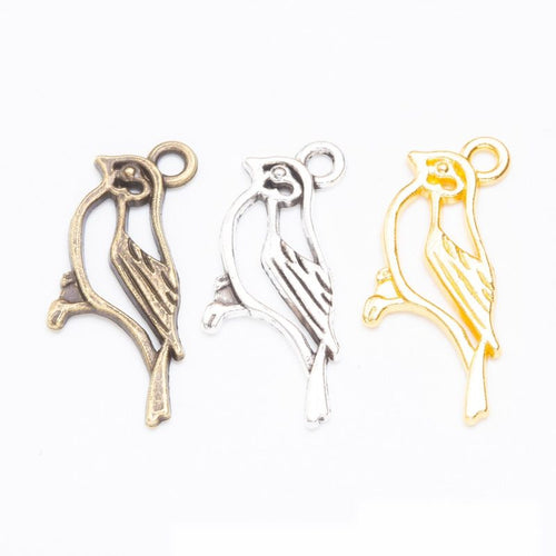 Product photo 1 of the bird on branch charm highlighting its open bird silhouette perched on a short branch