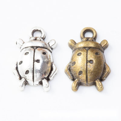 Grouped front view of ladybug connector showing a domed spotted back and loops at both ends