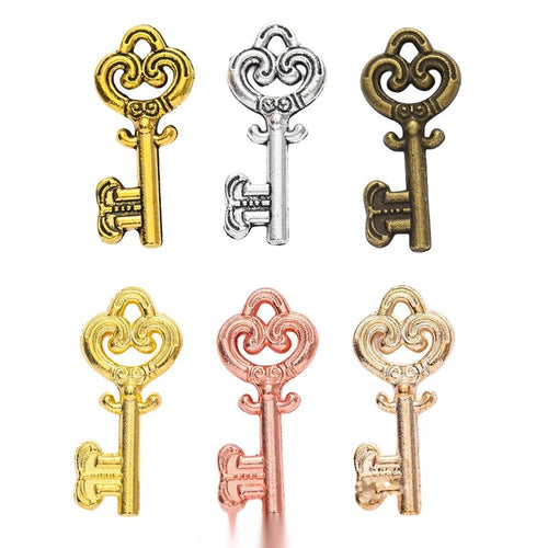 Assorted scrollwork heart key charm shown from the front
