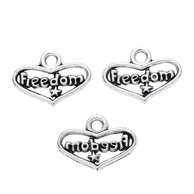 Grouped front view of freedom heart word charms in the available finishes