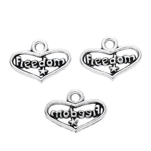 Grouped front view of freedom heart word charms in the available finishes