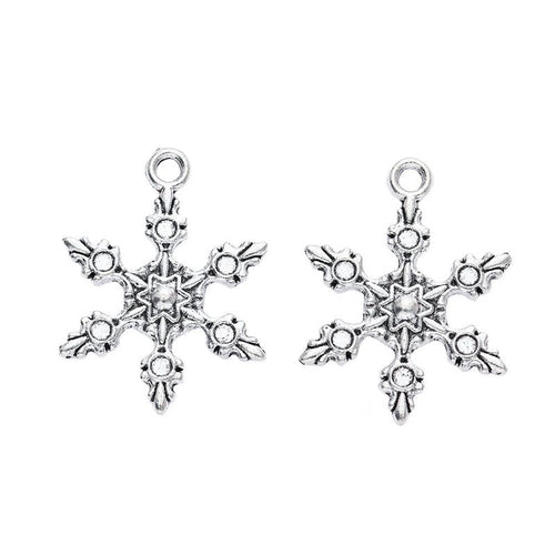Front-facing arrangement of dendrite snowflake charms on a white background