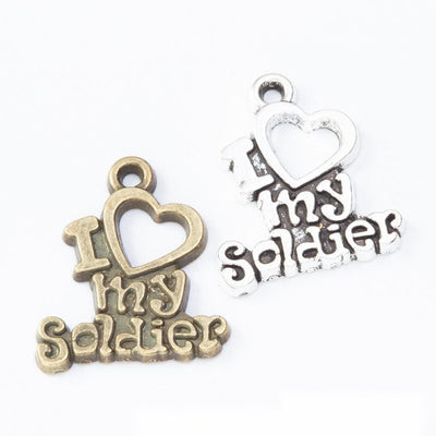 I Love My Soldier Heart Metal Word Charms in multiple metallic finishes displayed together on a white background.