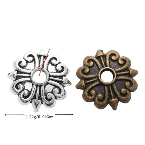 Assorted floral bead caps arranged together on a white background