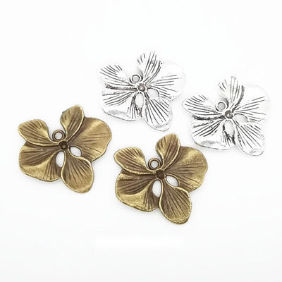 Assorted four petal flower connectors displayed together on a white background