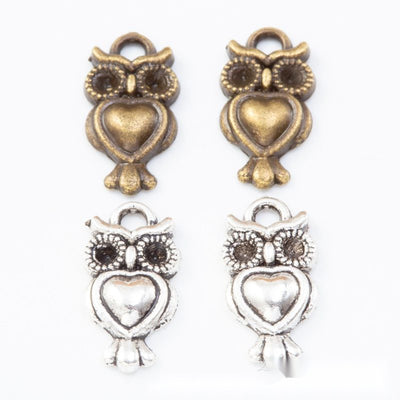heart belly owl metal charms in two antique finishes shown together in the available finishes