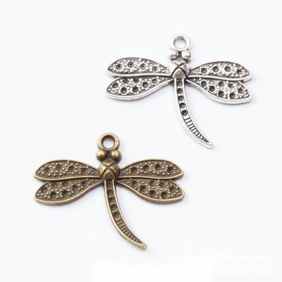 Grouped front view of textured dragonfly charms in the available finishes