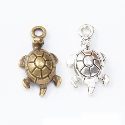 Raised Shell Turtle Metal Charms in Two Finishes in multiple metallic finishes displayed together on a white background.