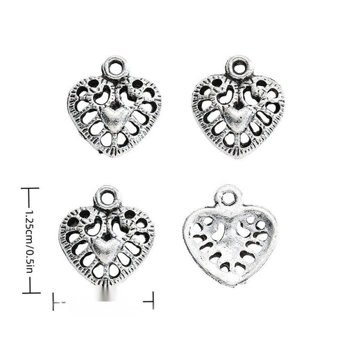 Front-facing arrangement of openwork floral heart charms on a white background