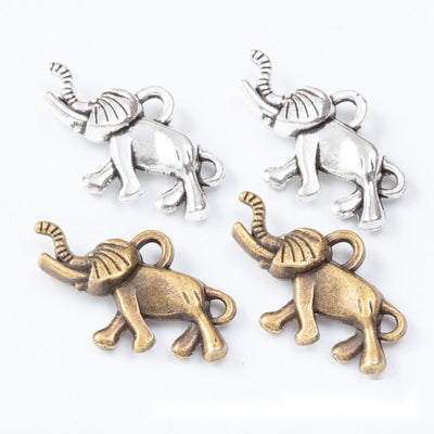 Group view of a walking elephant silhouette has etched decorative markings