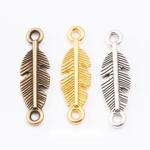 Grouped front views of the double loop feather connector charm in three metal finishes