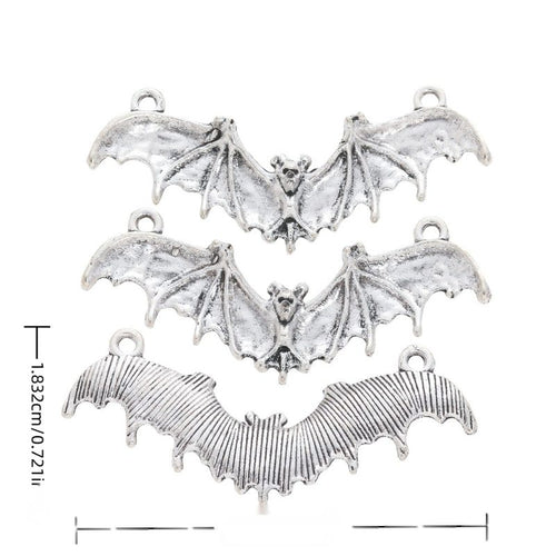 Front and reverse views of three flying bat charms with measurement and weight guides