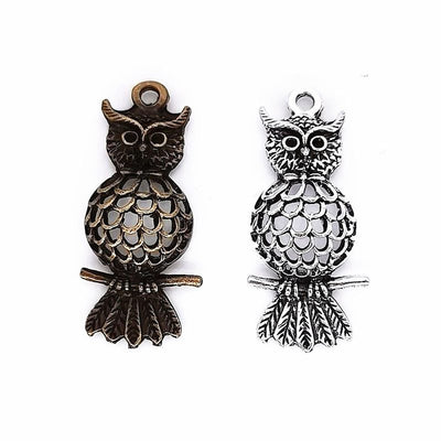 Perched owl metal component, grouped front view on white