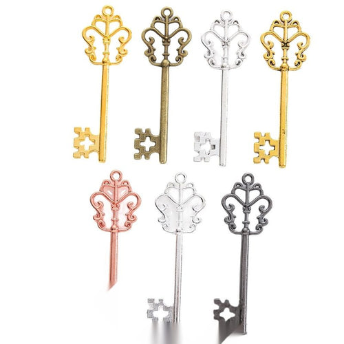Overview of ornate crown key charm pieces on a white background