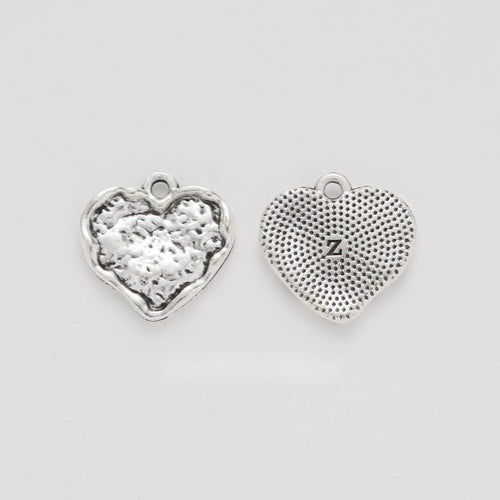 Grouped front views of the embossed floral heart charm in available finishes