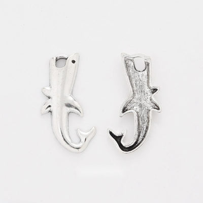 Curved Shark Charm shown in all pictured finishes on a white background