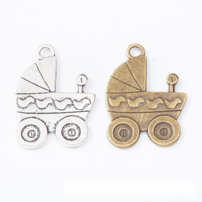 Group view of the baby carriage charm showing the available finishes and front details