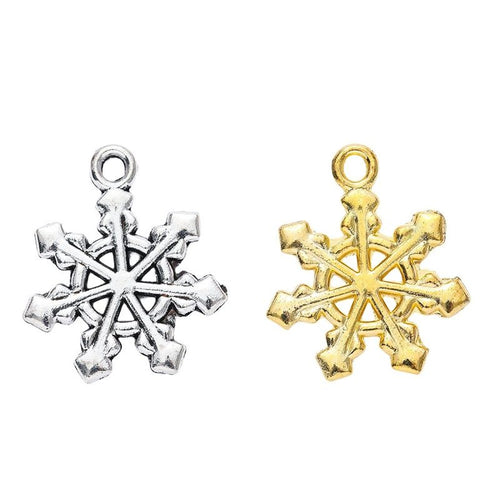 Front-facing arrangement of layered snowflake charms on a white background