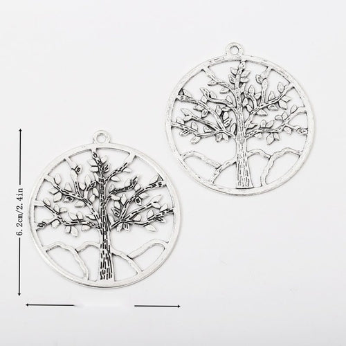 Overview of the large round tree charm in the available metal finishes