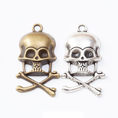 helmet skull and crossbones charms in two finishes shown together in the available finishes