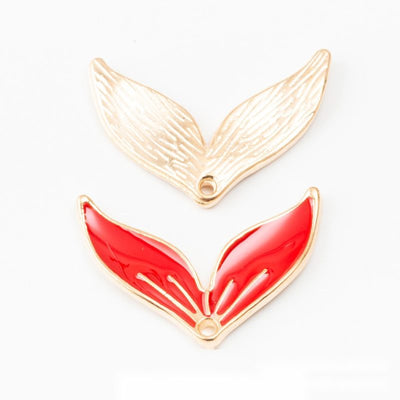 Group view of stylized whale tail with glossy enamel and a top loop