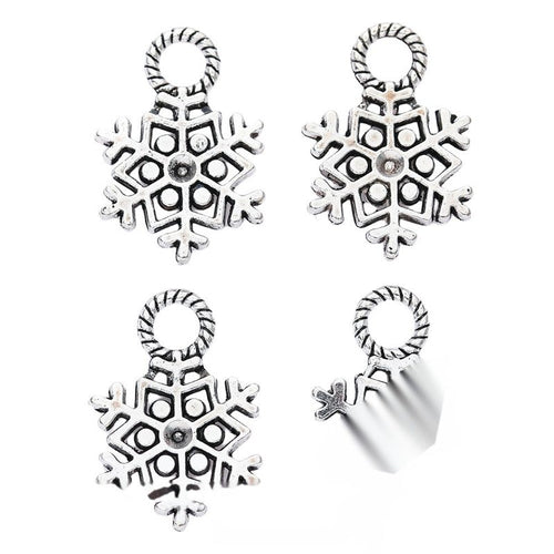 Front-facing arrangement of openwork snowflake charms on a white background