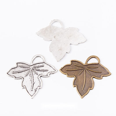 Outlined Maple Leaf Metal Charm Pendant shown in the available visible finishes