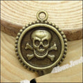 Skull and Crossbones Round Medallion Charm in Antique Bronze view 1