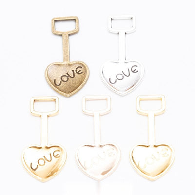 LOVE heart shovel metal component, grouped front view on white