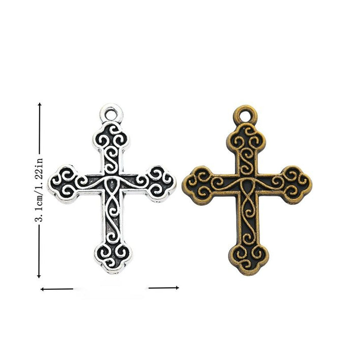 Ornate Cross Charm with scrollwork across a broad cross silhouette in 2 Metal Finishes