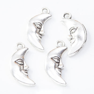 Group view of the moon face charm showing the available finishes and front details