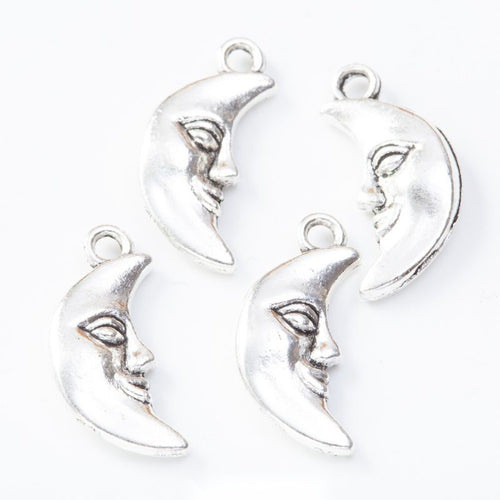 Group view of the moon face charm showing the available finishes and front details