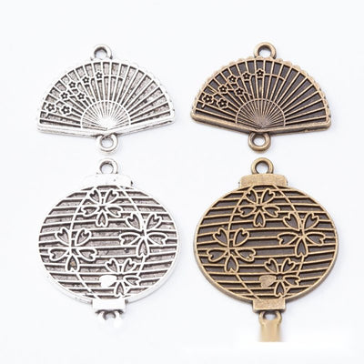 Double-loop connectors shaped as folding fans or round lanterns arranged together on a white background.