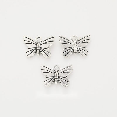 Front-facing arrangement of dragonfly charms on a white background