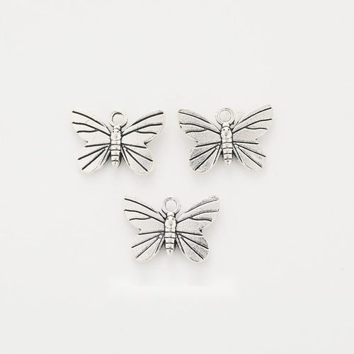 Front-facing arrangement of dragonfly charms on a white background