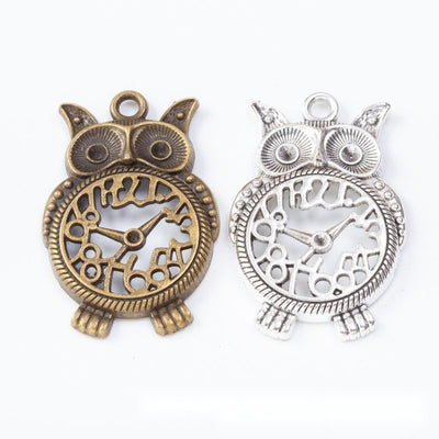 Group view of the owl clock charm showing the available finishes and front details