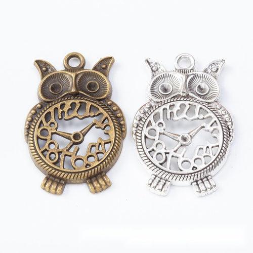 Group view of the owl clock charm showing the available finishes and front details