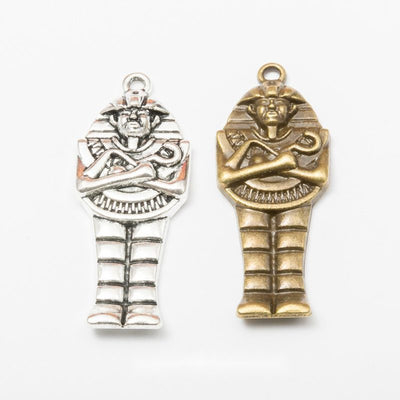 egyptian mummy figure metal charms in two finishes shown together in the available finishes