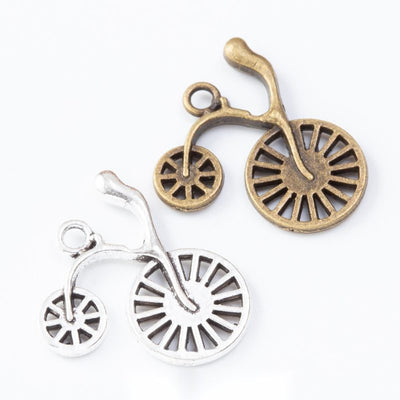 Group view of the penny-farthing bicycle charm showing the available finishes and front details