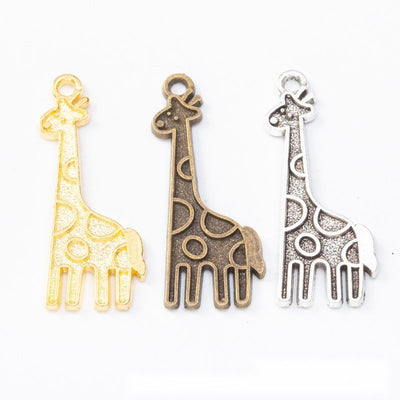 Assorted tall giraffe charms arranged together on a white background
