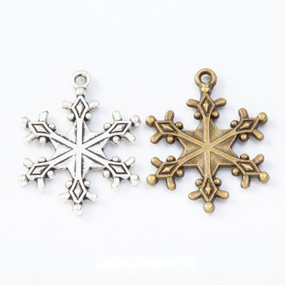 Detailed snowflake charm shown across the available finishes
