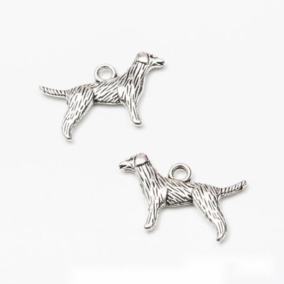 Product view of standing dog charm showing a standing dog silhouette with engraved fur texture and a top loop